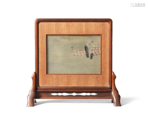 An inlaid shibuichi rectangular panel framed within a wood k...