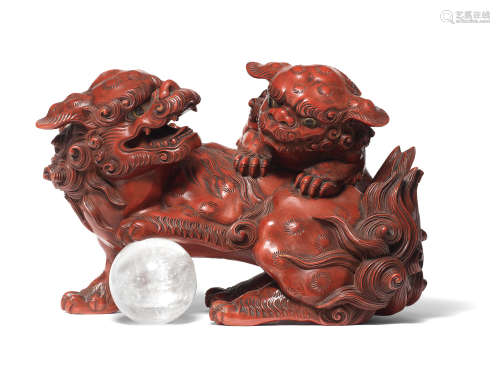 A red-lacquered wood group of two shishi (Chinese mythologic...
