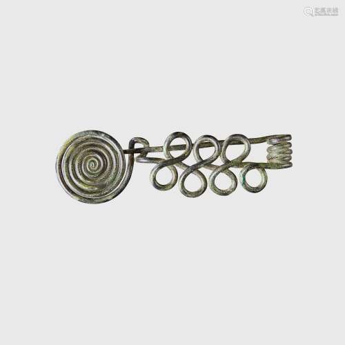 BRONZE AGE COILED BROOCH CENTRAL EUROPE, C. 11TH - 10TH CENT...