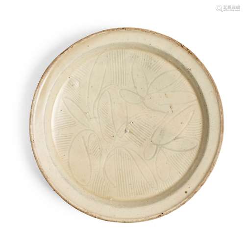 CIZHOU WHITE-GLAZED CARVED 'FLORAL' DISH NORTHERN SONG OR JI...