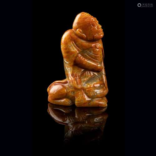 CELADON JADE WITH RUSSET SKIN CARVING OF A SEATED ARHAT LATE...