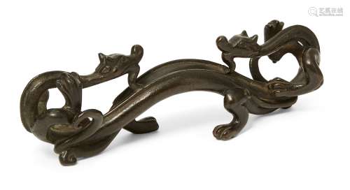 A Chinese bronze 'chilong' brush rest, Ming dynasty, 17th ce...