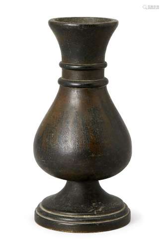 A Chinese bronze vase, 17th century, cast with a bulbous, pe...