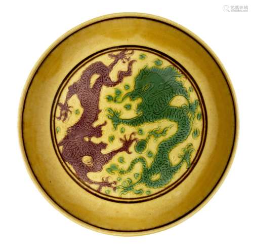 A Chinese yellow-ground aubergine and green-decorated saucer...