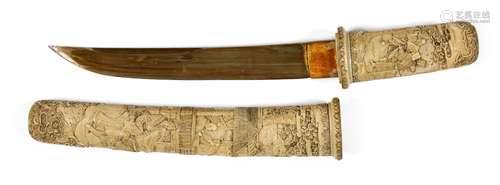 A Japanese carved ivory tanto, Meiji period, in slightly cur...