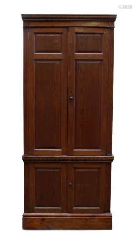 A stained pine hall cupboard, late 20th century, with moulde...