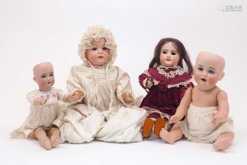 A group of four dolls, late 19th / early 20th Century, to in...