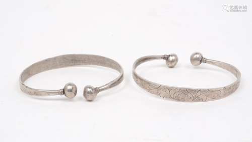A pair of Chinese white metal bangles, 20th century, with in...