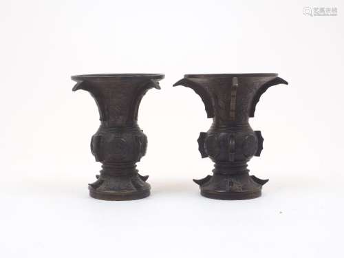 A pair of Japanese bronze vases, Meiji period, of an archais...