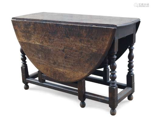 An oak gate leg table, 18th century, the oval top with two d...