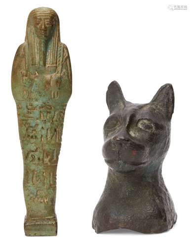 A green glazed composition shabti of typical form, holding t...