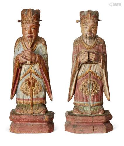 A pair of Chinese carved wood officials, early 20th century,...