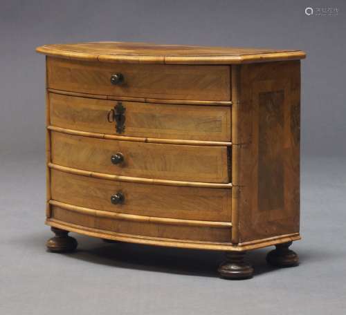 A Continental walnut and crossbanded miniature chest of draw...
