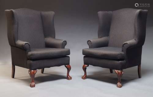 A pair of George III style wingback armchairs, second half 2...
