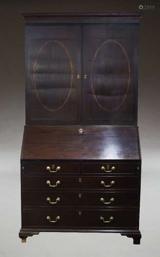 A George III mahogany bureau bookcase, the moulded cornice o...