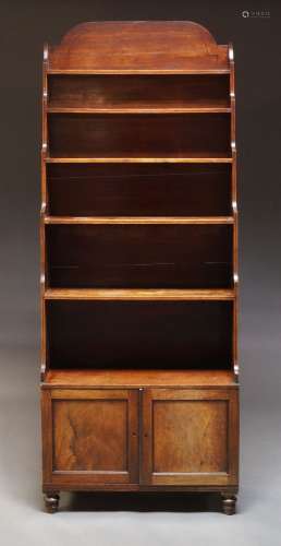 A large Victorian waterfall bookcase, the shaped top above f...