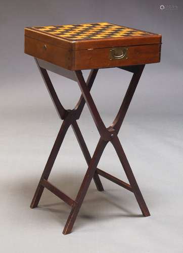 A mahogany games box on stand, with reversible top, having p...