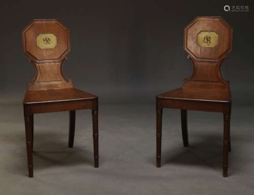 A pair of Regency mahogany hall chairs, with octagonal backr...