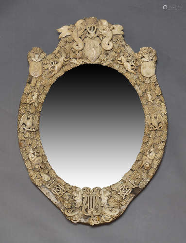 A Dieppe ivory and bone mirror, c.1870, the cresting centred...