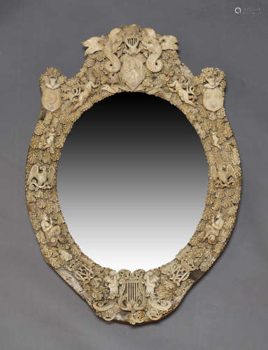A Dieppe ivory and bone mirror, c.1870, the cresting centred...