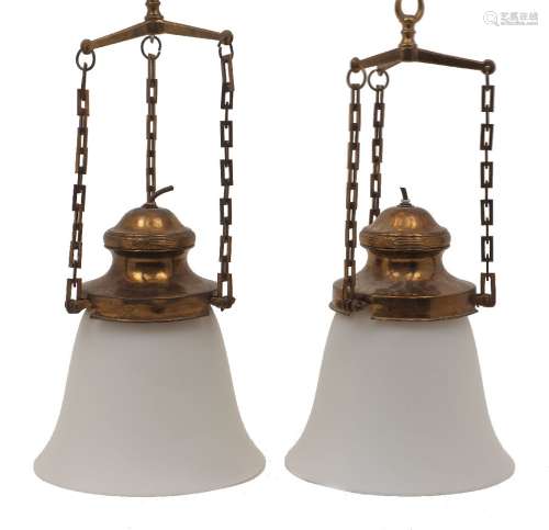 A pair of brass and white glass hanging lights, 20th century...