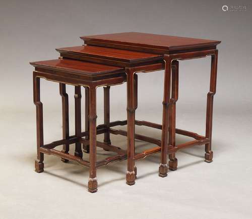 A Chinese stained wood nest of tables, 20th Century, the rec...