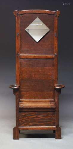 An Edwardian hall seat, the raised back mounted with square ...