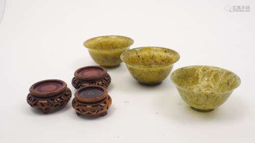 Three Chinese spinach jade bowls, late 19th century, each sl...