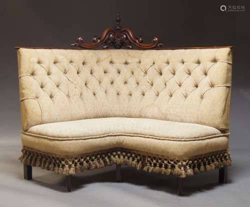 A Victorian corner sofa, the carved and pierced crest with t...
