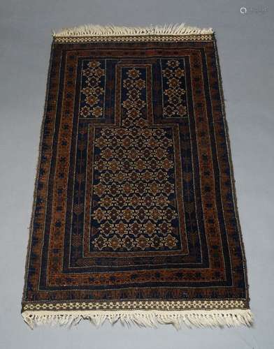 A Belouch prayer rug, the charcoal ground mihrab, with repea...