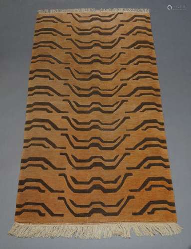 A Chinese rug with all over wave design in a pale orange fie...