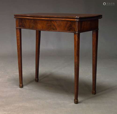 A George III mahogany serpentine card table, the fold-over t...