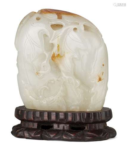 A Chinese pale green and russet jade boulder carving, 20th c...