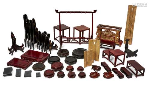 A large collection of Chinese wood stands, 20th century, to ...