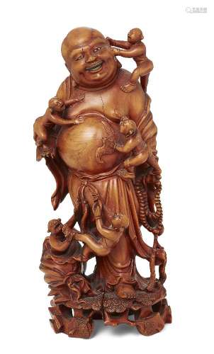 A Chinese carved wood figure of Budai, late 19th/early 20th ...