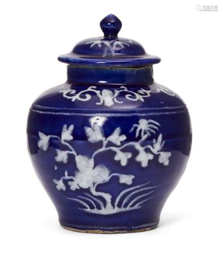 A Chinese slip-decorated blue-glazed jar and cover, Ming dyn...