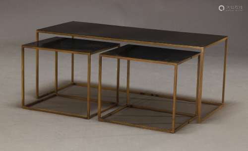 A modern coffee table with two nesting side tables, of recen...
