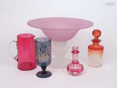 A decorative glass centrepiece, designed with pink flared bo...