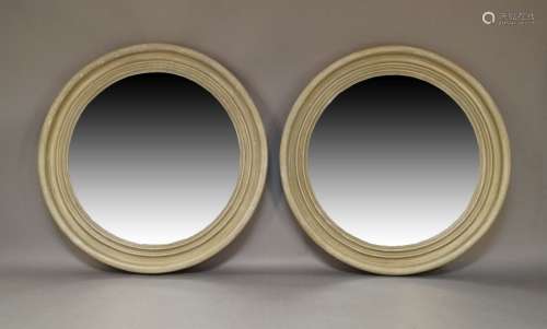 A pair of circular convex mirrors, 20th Century, each with s...