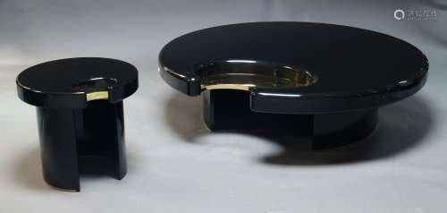 A contemporary black lacquered coffee table in the manner of...
