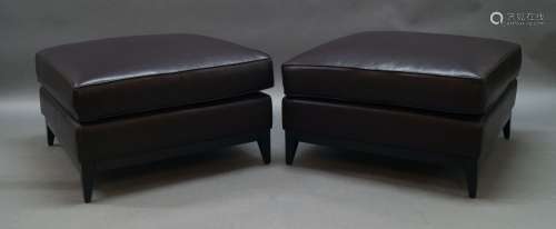 A pair of contemporary brown leather footstools, of recent m...