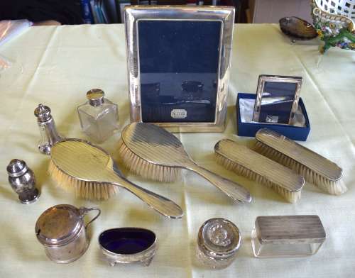 AN ART DECO SILVER DRESSING TABLE SET together with two silv...