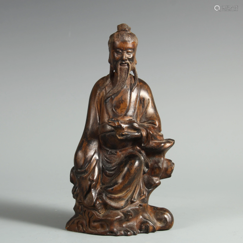 A CHINESE AGARWOOD CARVING DECORATION OF SEATED …