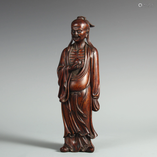 A CHINESE AGARWOOD CARVING OF STANDING FIGURE