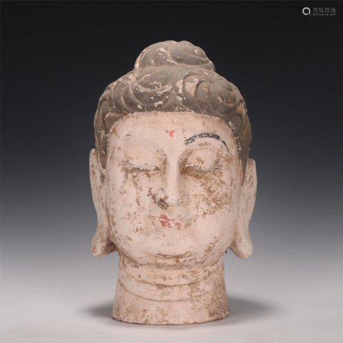 A CHINESE POTTERY BUDDHA HEAD OF SAKYAMUNI