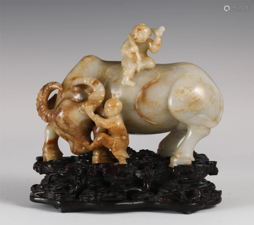 A CHINESE JADE CARVING OF TWO KIDS RIDING A BUFFALO