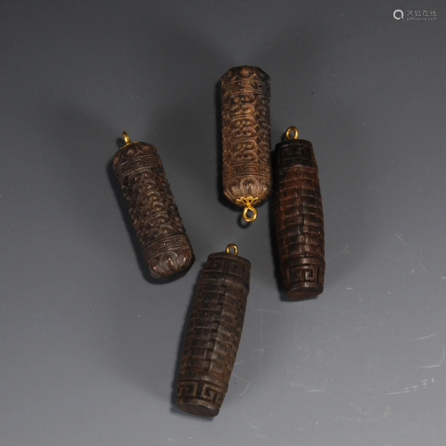A GROUP OF FOUR CHINESE AGARWOOD PENDANTS