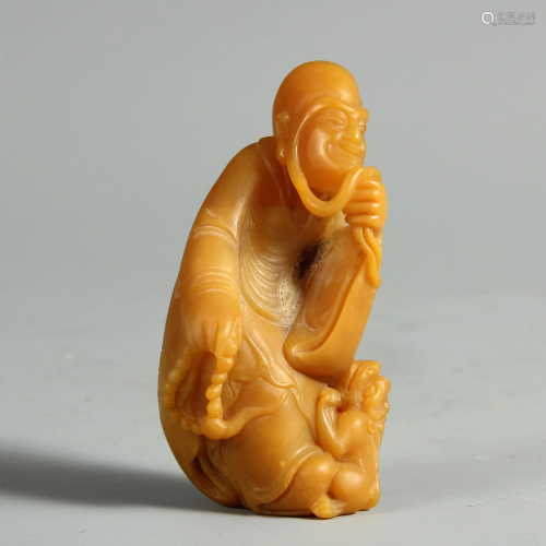 A CHINESE SOAPSTONE CARVING OF FIGURE