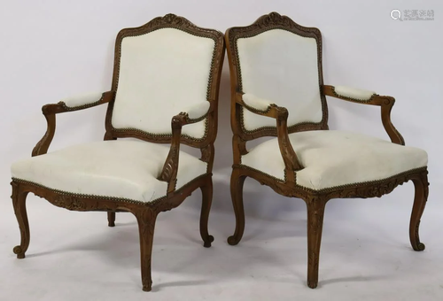 A Pair Of Louis XV Style Carved Arm Chairs .