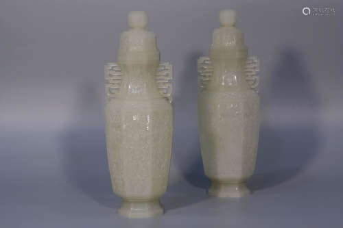 A pair of white jade carved lotus vases